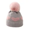 A grey woolen hat paired with a pink woolen heart-shaped pattern warm knitted women's hat Item Picture